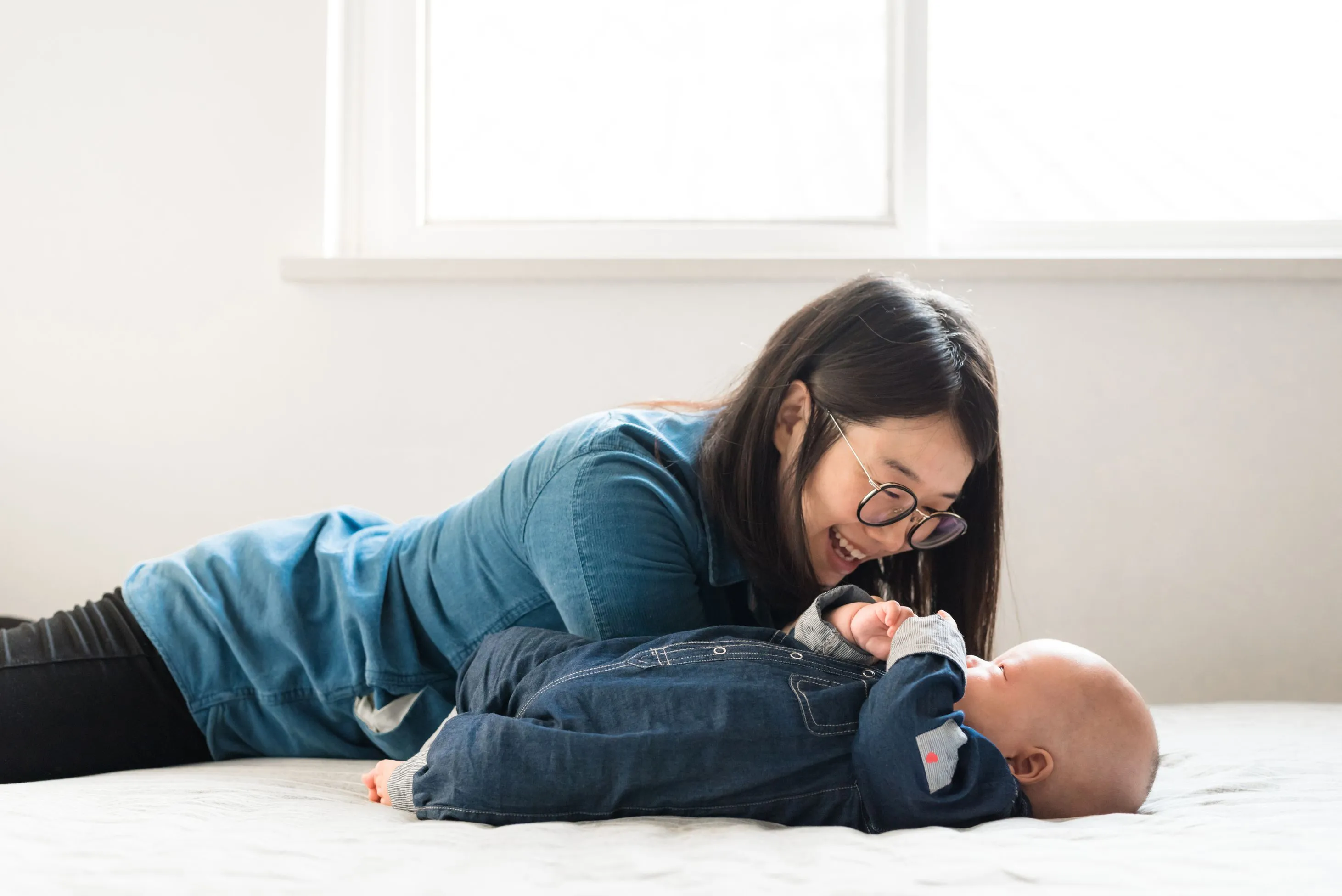 A mother affectionately playing with her baby.