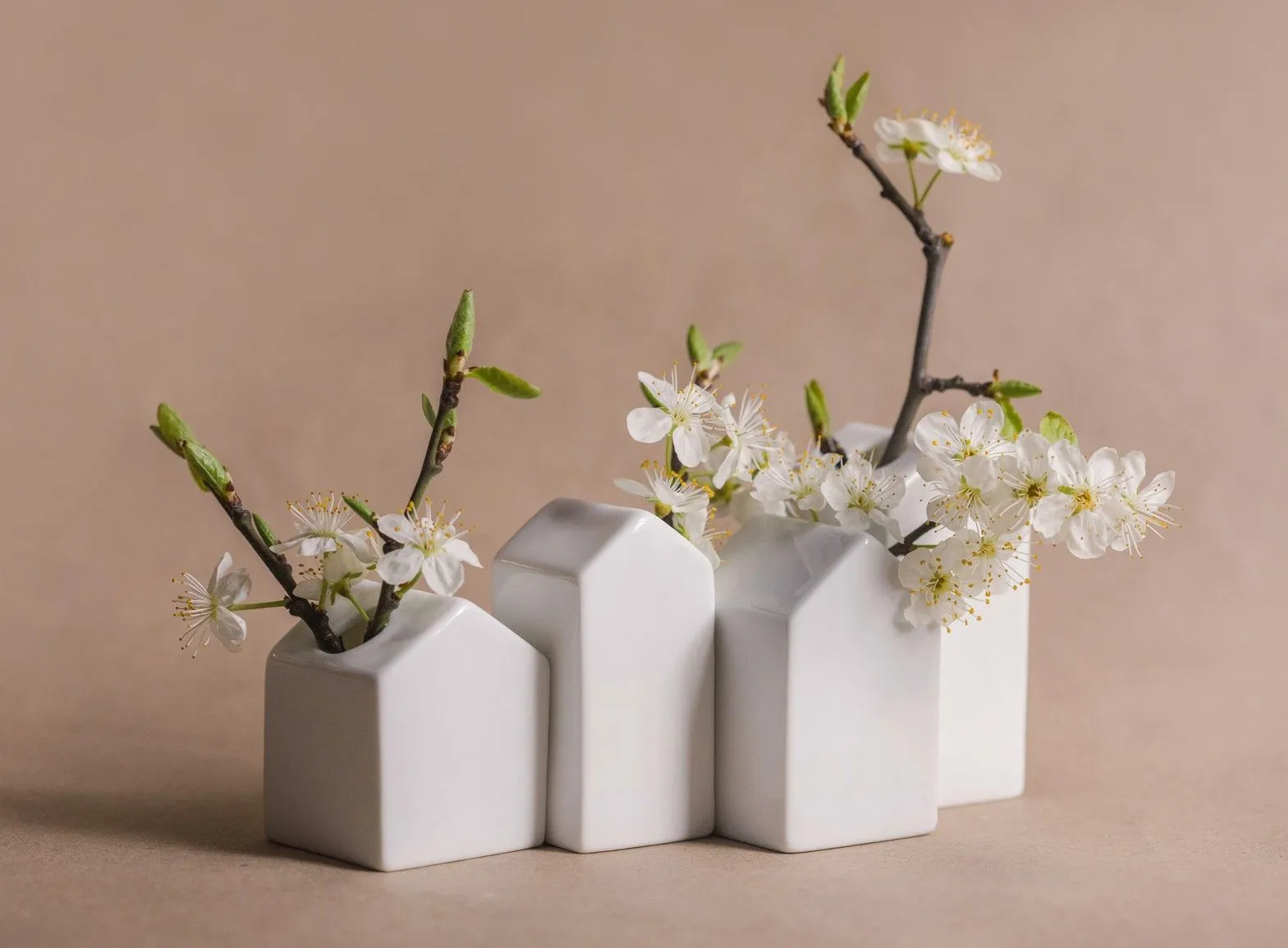 Cherry blossoms in house shaped vases